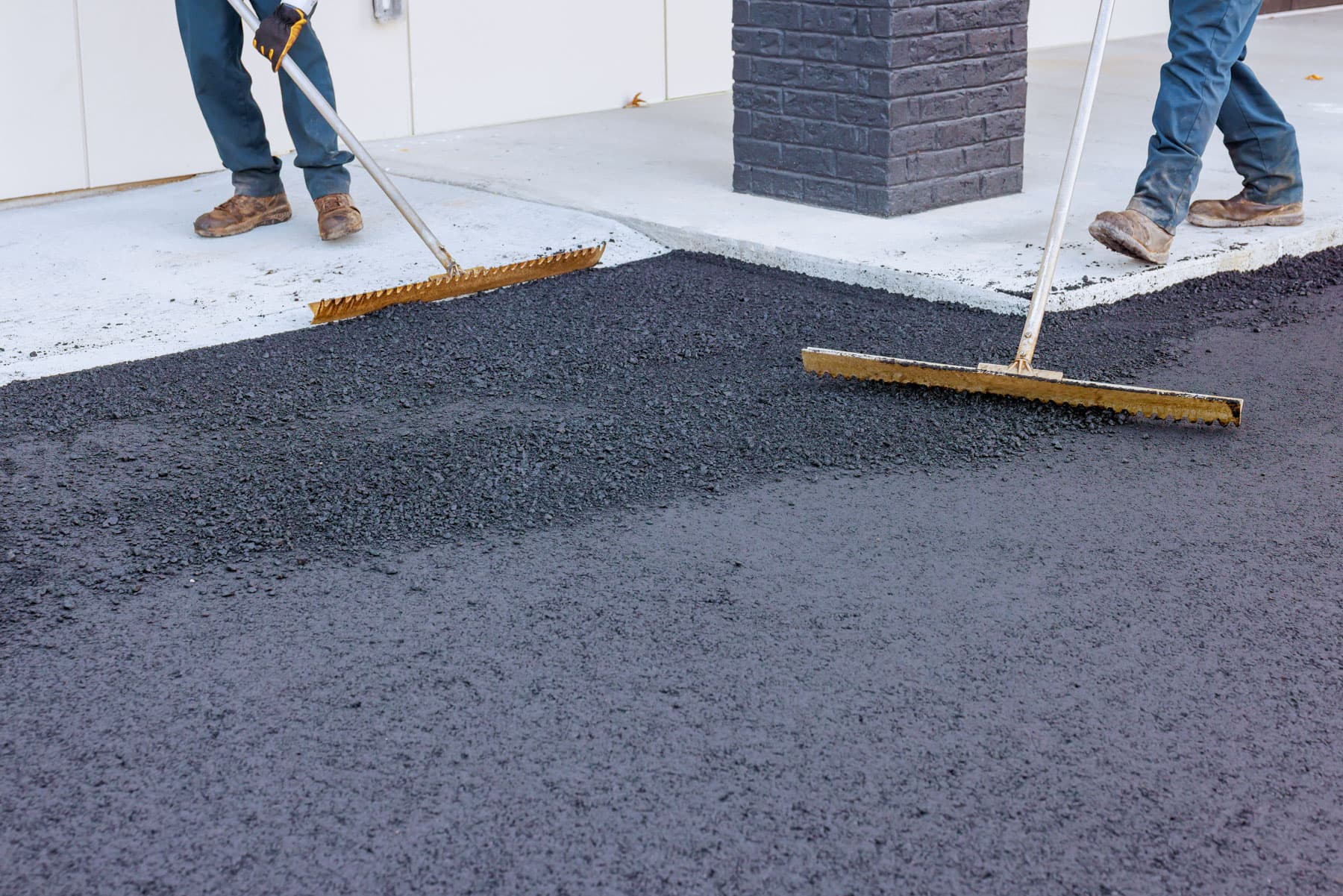 Surrey Asphalt Pros crew spreading fresh asphalt in Surrey